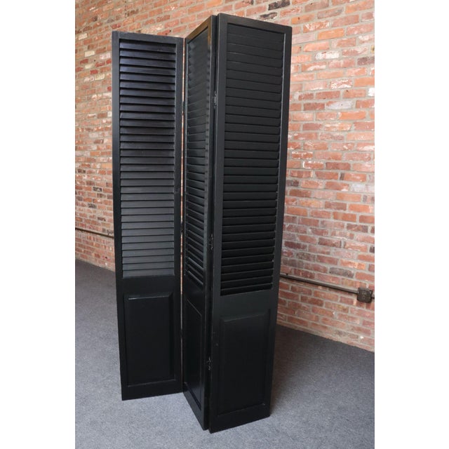 Vintage shutter-form three panel screen/room divider with segmented mirror front and decorative brass lion pulls (ca....