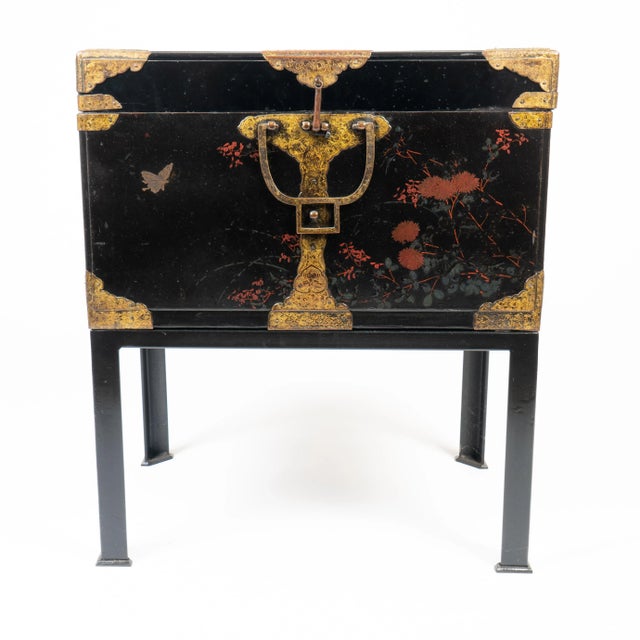Japanese black lacquered wood trunk with engraved cast brass corner mounts and bails for the lift off cover. The brasses...
