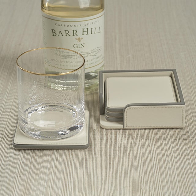 Refined yet practical, this set of four square leather coasters is designed to protect surfaces while elevating the...