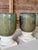 A striking pair of large-scale glazed ceramic garden planters presented on separate classical-style cast stone pedestal...
