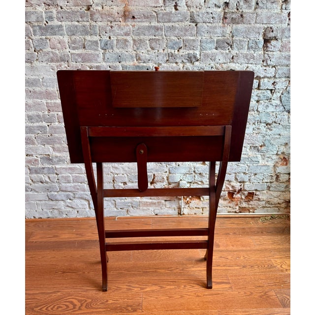 England, circa 1900, folding form opens to a green felt game service, single drawer labeled "Bridge," beneath an inlaid...