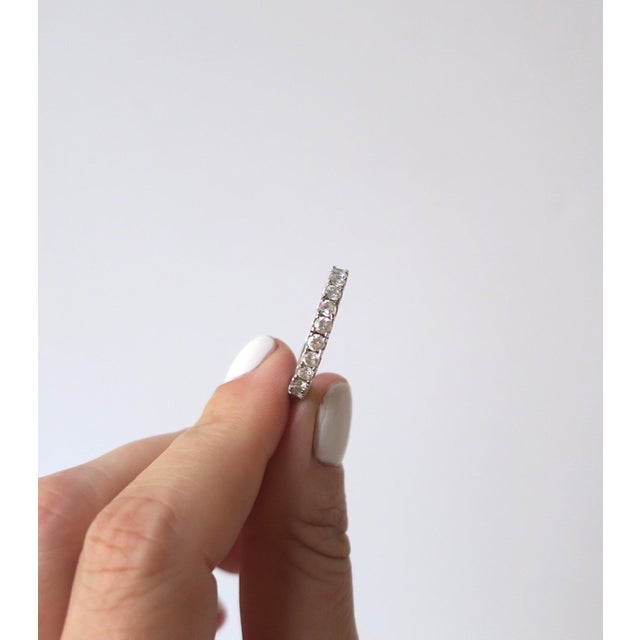 Eternity band faux-diamond cubic zirconia set in 18kt white gold-filled as marked on inside '18kt GF'. Ring is a size 8....