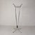 Model featuring four upward-facing tubes topped with black plastic caps. Equipped with 12 sliding hooks. The chrome finish...