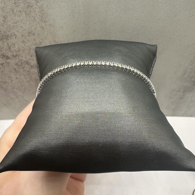 This classic natural diamond tennis bracelet in 14kt white gold features 1.70 carats total weight of GH SI1–I1 round...