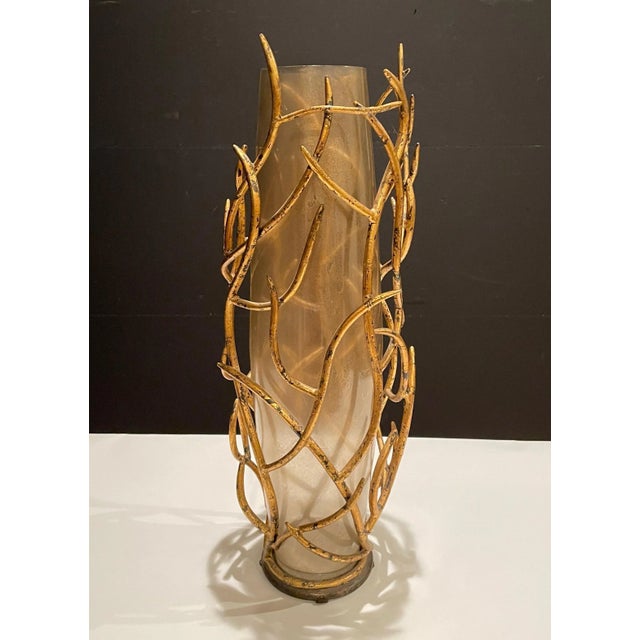 Freeform gilt iron tree branch, floral stem styling and gold fleck art glass vase. Tapered cylindrical gold fleck tinted...
