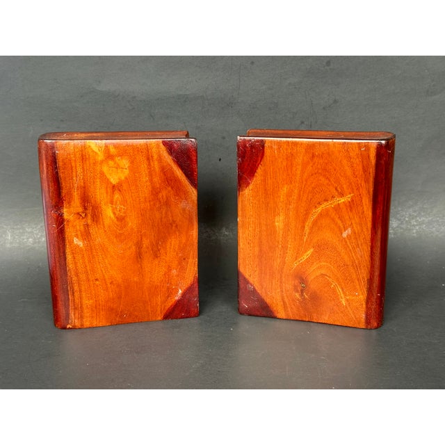 Handcrafted to look like books, this set of wooden bookends is the quintessential library shelf or home office accessory...