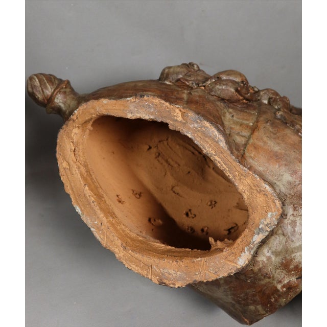 Terracotta sculpture Large terracotta sculpture depicting a child on a jar. We have not found a signature on this...