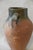 This antique Mediterranean olive jar has a rich, weathered green glaze, rounded form, and two sturdy side handles that...
