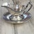 "An elegant vintage silver-plated gravy boat featuring a paneled, multi-faceted body by the renowned silversmiths Reed &...