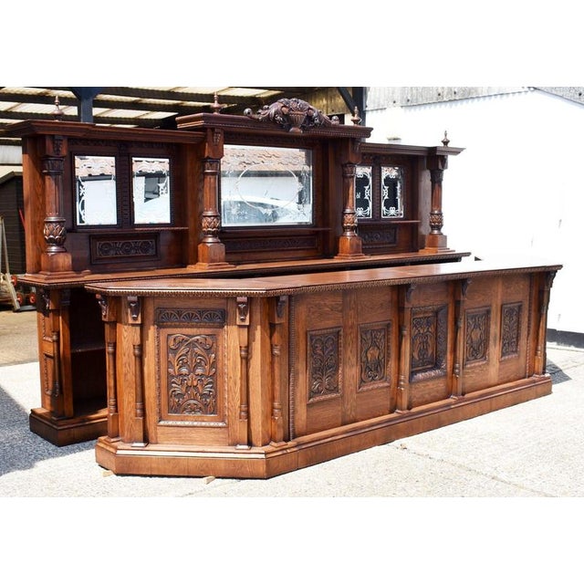 Monumental Carved Oak Front and Back Bar An impressive carved oak front and back bar, designed in the Victorian taste and...