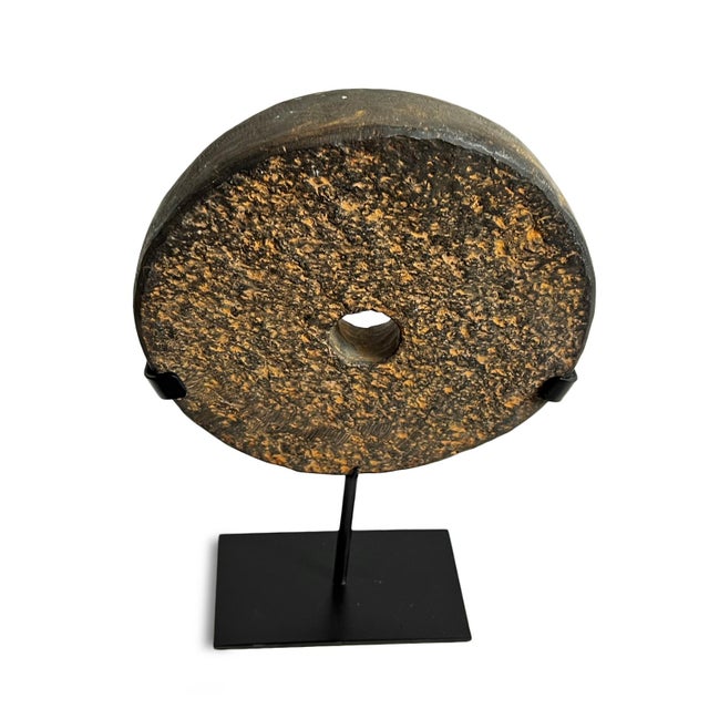 Beautiful modern style vintage black stone disk on iron stand. Textured chiseled stone each unique in natural qualities....