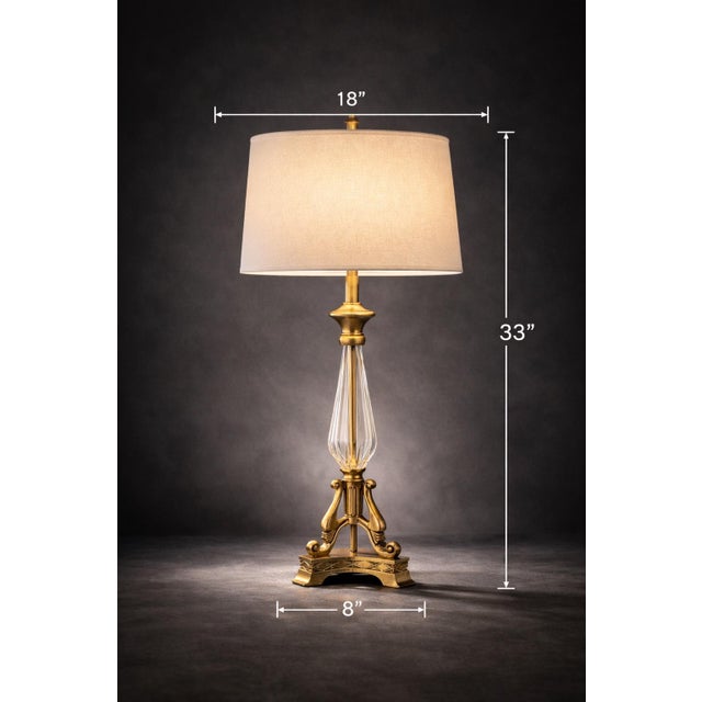A commanding pair of tall neoclassical table lamps, featuring fluted glass columns and a refined sunlit brass finish....