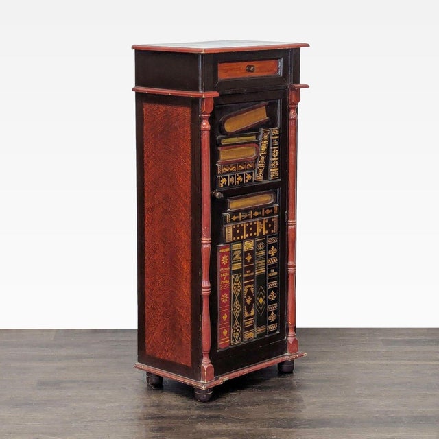 One drawer cabinet with faux book door and interior shelving. Dimensions (in): 23W x 15D x 51H.