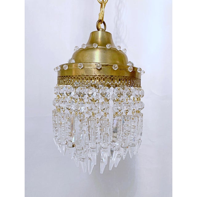 This is a decorative Italian layered chandelier with brass dome and 30% spear faceted crystal drops. It has 1 Edison base...