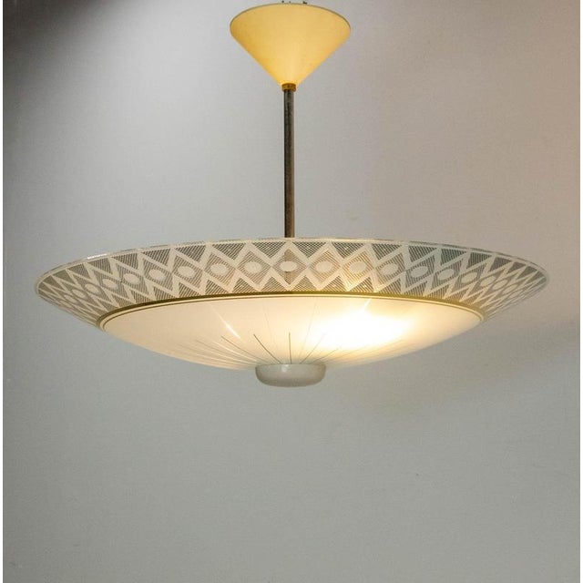 Lustre made in the 1950 years with glass in an umbrella shape. Needs two b22 bulbs a golden circle adds to the refinement...