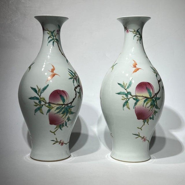 Pair of vintage Chinese export porcelain vases with beautiful peach designs, each 16.5 by 7 inches with marks of the...