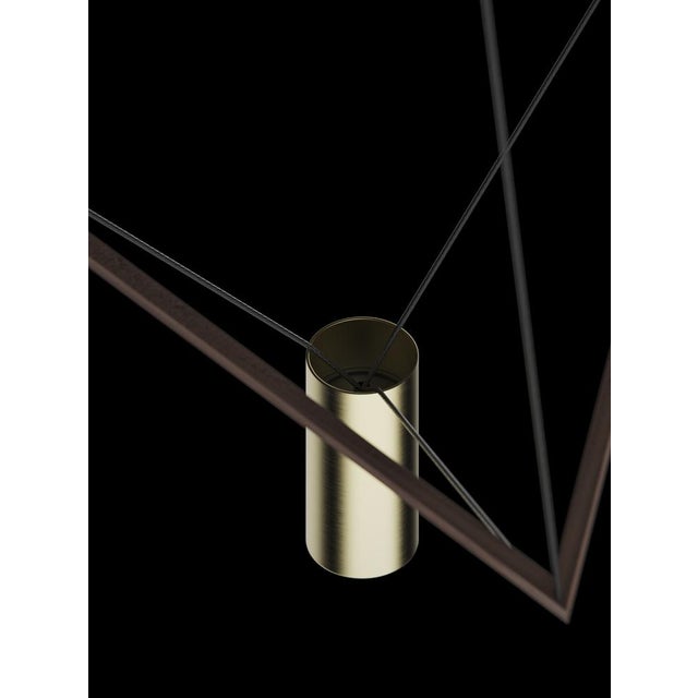 Ceiling lamp with natural wood structure and brushed brass lampshade. The wooden triangular structure can be freely tilted...