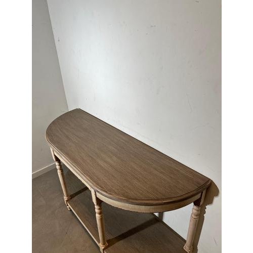 Beautiful vintage half moon console table with elegant turned legs and a charming distressed finish. The combination of...
