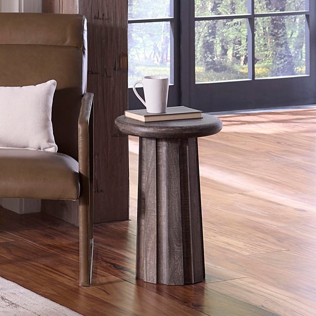 Handcrafted from solid mango wood and finished in a soft gray wash, this sculptural side table brings warmth, depth, and...