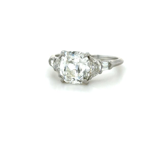 This gorgeous ring by Leon Megé boasts a 2.70 carat old mine cut diamond flanked by two half moon diamonds and bullet...