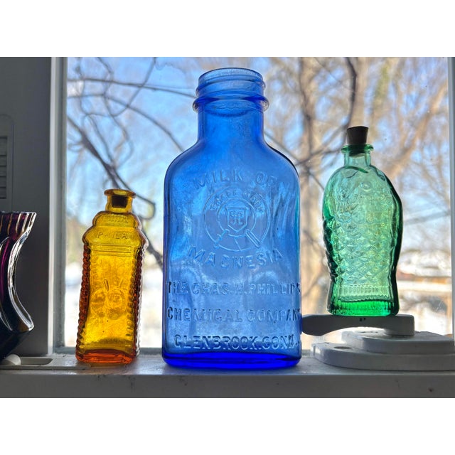 Antique cobalt blue glass Milk of Magnesia bottle, pat. Aug 21, 1906, and produced by the Chas. Phillips Chemical Co. in...