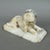 A fine freestanding white marble sculpture depicting a crouching lion, attributed to early 20th-century craftsmanship....