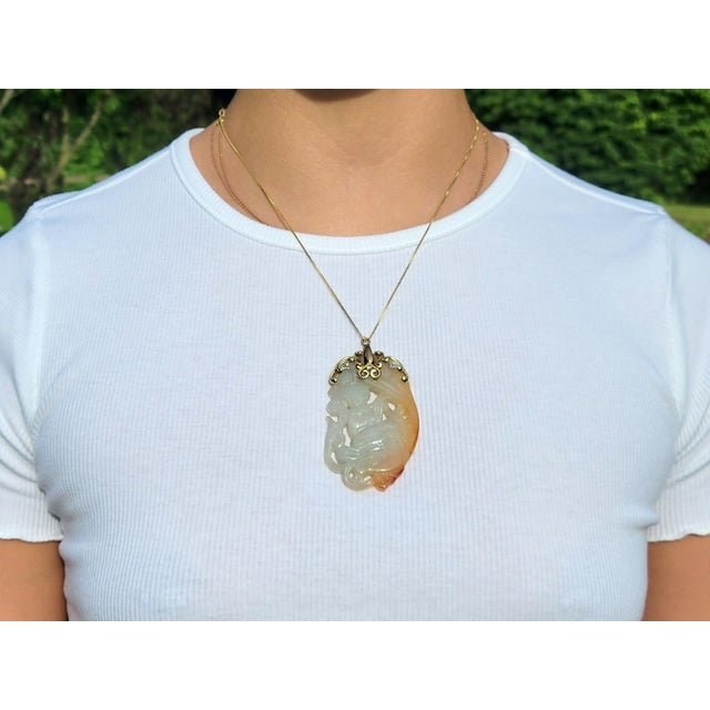 A marvelous item featuring a massive piece of carved variegated white and orange jade depicting the goddess Guanyin. For a...