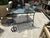 Mid-century modern black bar cart with glass top, perfect for serving drinks on the patio. Has been powder coated to...
