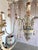 Monumental Italian 12-light chandelier. Hand-carved wood frame with original painted finish in layered tones of sage...
