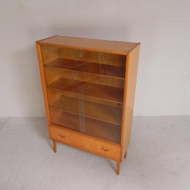 Display your finest collection, dinnerware, or glassware in this beautiful cabinet. The cabinet has a few shrinkage...