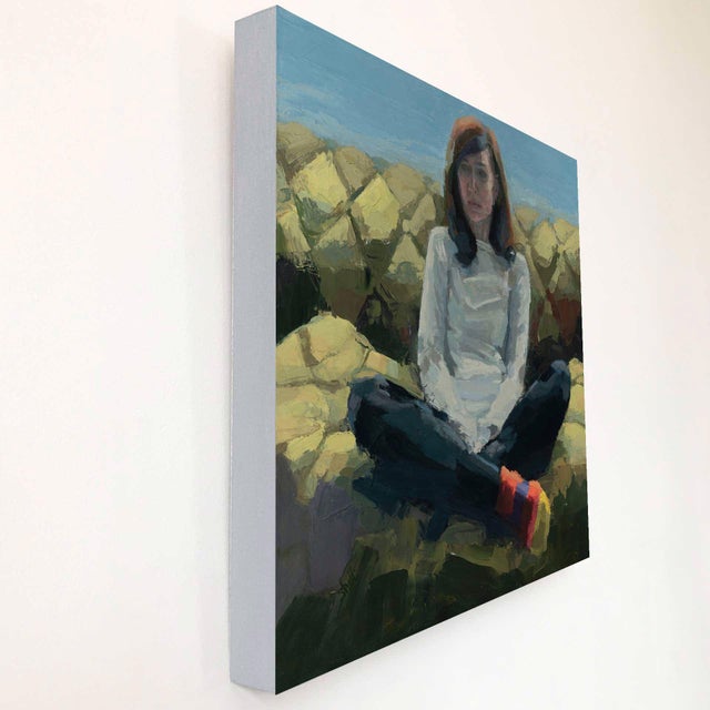 The artwork depicts a seated figure with an introspective expression, dressed in a white sweater and dark jeans,...
