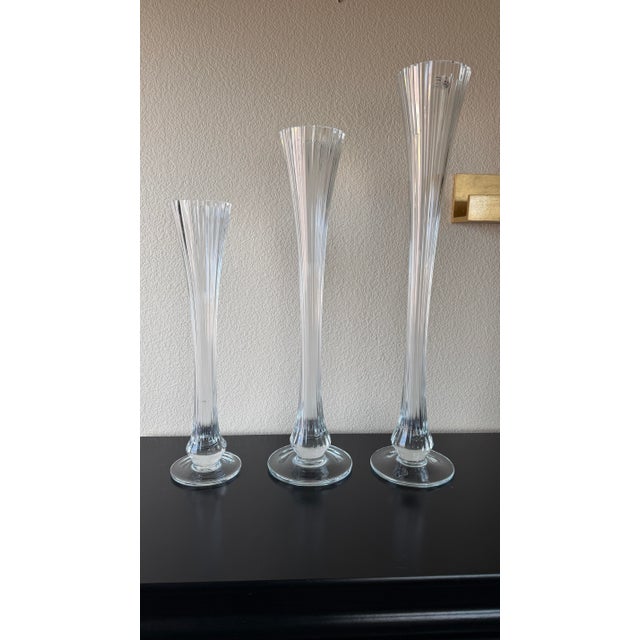 An elegant graduated set of three authentic Global Views hand-blown glass candlesticks crafted in Portugal and retaining...