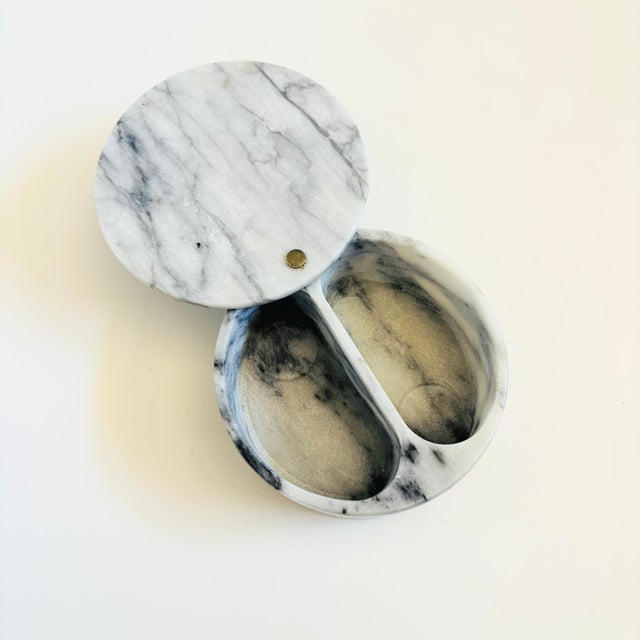 A vintage circular marble box. Beautiful natural gray veining. Features a swiveling lid and a divided compartment within....
