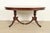 An exceptional Georgian or Regency style double pedestal extension dining table In the manner of Baker Furniture USA,...