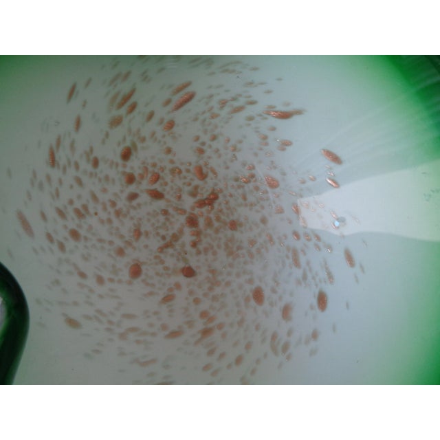 This beautiful bowl that appears to be vintage Murano is green and white with aventurine.