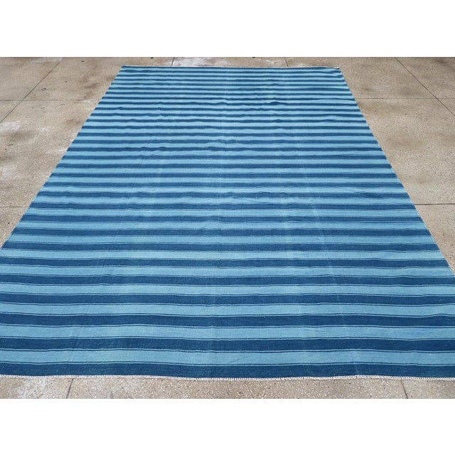 A Vintage Indian Flatweave Dhurrie Room size Carpet handmade during the Mid-20th century. Measures: 8' 8" x 12' 7"