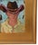 Impressionist oil painting on an artist's hardboard panel of a western cowboy with a hat displayed in a complementary...