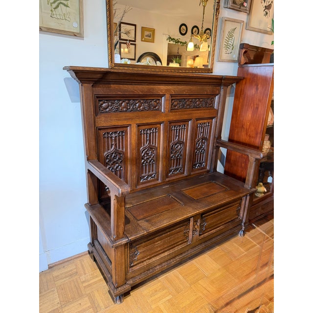 This stunning oak bench has dramatic carving with panels featuring gothic motifs and other panels displaying a stylized...