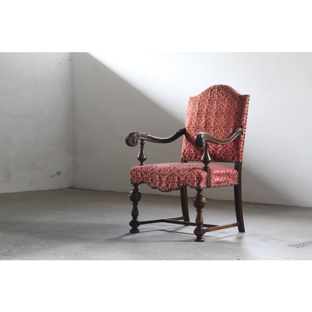 A magnificent example of 19th-century European craftsmanship, this armchair is a study in sculptural elegance and...
