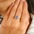 Elegantly minimal yet undeniably captivating, this 14k white gold ring showcases a brilliant 1.57 carat oval-cut blue...