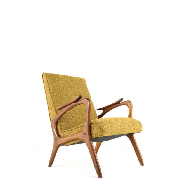 This mid-century modern armchair is an elegant example of organic design from the 1950s and 1960s. The fully restored teak...
