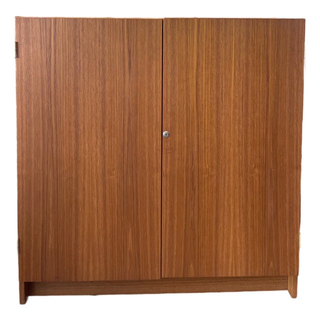 A beautifully crafted vintage teak desk cabinet with lock and key, designed in the style of the iconic Swiss duo...