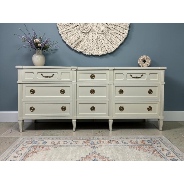 An authenticated vintage triple dresser by American of Martinsville with its original maker’s mark intact. Its long,...