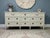 An authenticated vintage triple dresser by American of Martinsville with its original maker’s mark intact. Its long,...