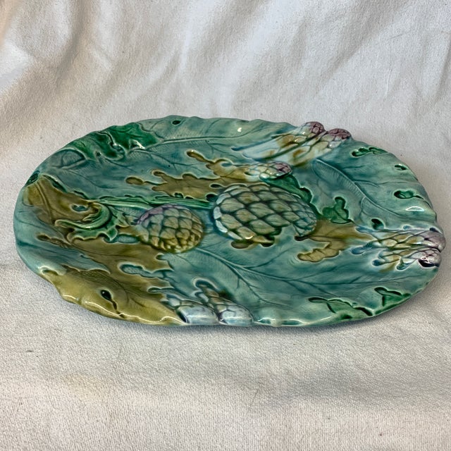 This is a vintage French Art Nouveau majolica asparagus and artichoke serving platter, specifically crafted by Keller &...