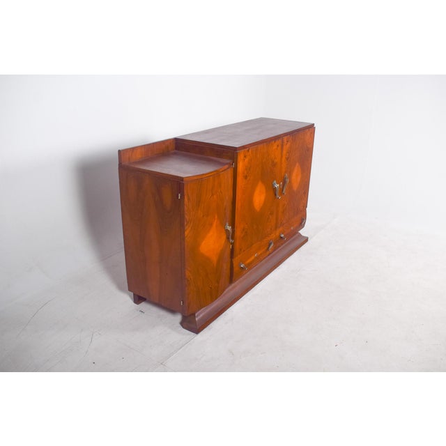 Art Deco sideboard. with a symmetrical and well-balanced design, the piece features doors covered with natural wood...