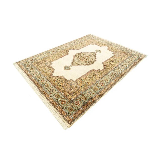Rug from the 1960s. High-quality flor with a medallion on creamy background with a border in mint, red, cream, brown and...