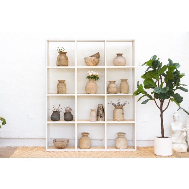 This magnificent bookcase is a study in rustic elegance and timeless design. This vintage 20th-century Acacia bookcase...