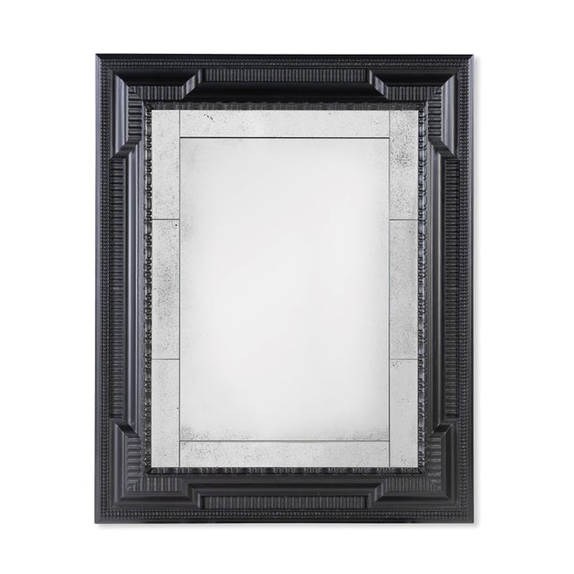 The 19th-century inspired ebonized Dutch Baroque-style mirror frame, featuring multiple paneled mirrors, reflects the...