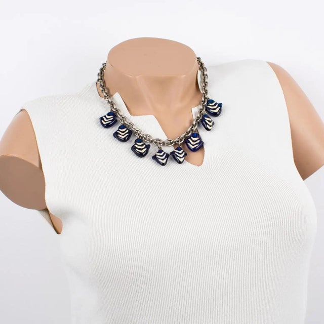 This stunning Kenzo Paris necklace features a heavy silvered metal chain adorned with Murano glass charms. The charm...